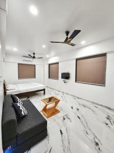 a living room with a couch and a flat screen tv at Nirved Retreat Resort - A Backwater Forest Peaceful Stay in Bhor, Pune in Āpti +13 photos