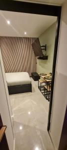 a bedroom with a bed and a table in a room at Apartment in Paris with Jaccuzzi in Paris