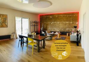 a living room with a table and a dining room at Nature loft, calme et confortable in La Murette +41 photos