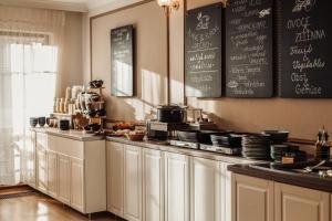 a kitchen with a counter with a chalkboard on the wall at Hygge Hotel U Zvonu in Vrchlabí