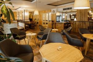 a restaurant with chairs and tables and a bar at Hygge Hotel U Zvonu in Vrchlabí +31 photos
