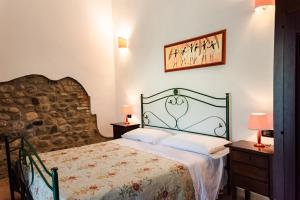 a bedroom with a bed and two night stands and two lamps at Il Casale Le Tre Volte in Solfara Mare
