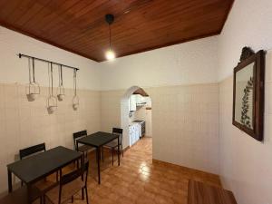 a dining room with two black tables and chairs at Casa das Muralhas in Peniche