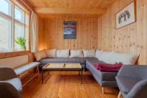 a living room with a couch and a table at Peaceful Home with Ocean Views in Elduvík in Elduvík