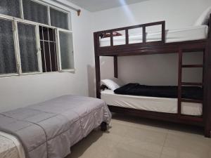 a bedroom with two bunk beds and a bed at Casa muy cerca de plaza central in San Cristóbal de Las Casas +6 photos