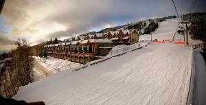 a ski slope with a ski lodge in the snow at Mountain Escape for Ski and Golf Enthusiasts in Kimberley