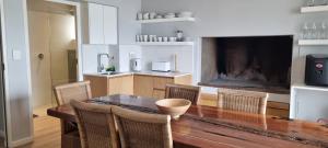 a dining room with a wooden table and chairs at 109 at Breede in Witsand