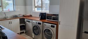 a kitchen with a washing machine and a sink at 109 at Breede in Witsand