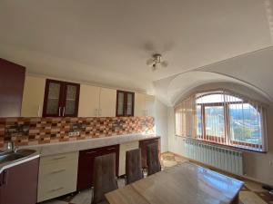an empty kitchen with a table and a window at Vila Lena in Cahul