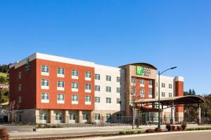 a hotel on a street in front of a building at Holiday Inn Express & Suites Hayward - Castro Valley by IHG in Hayward