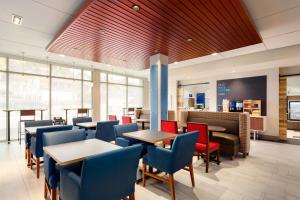 a restaurant with tables and chairs and a counter at Holiday Inn Express & Suites Hayward - Castro Valley by IHG in Hayward