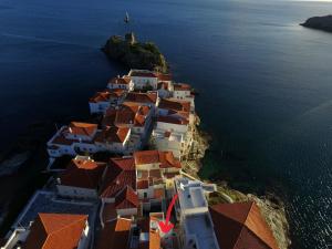 an aerial view of an island with red roofs at Camara Homes in Andros