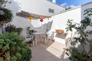 a patio with two chairs and a table with at Monolocale Garden in Giuggianello
