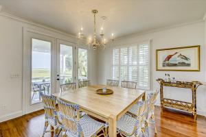 a dining room with a wooden table and chairs at Luna Sea in Edisto Beach