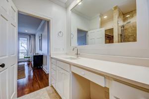 a white bathroom with a sink and a mirror at Luna Sea in Edisto Beach +38 photos