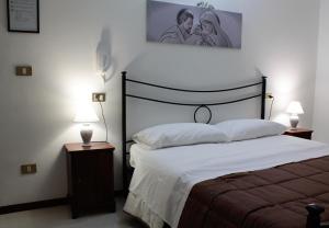 Postel nebo postele na pokoji v ubytování Hotel Il Vicoletto