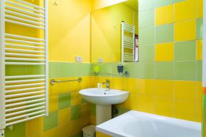 a bathroom with a sink and a mirror at Grazioso appartamento in campagna a Procchio in Marciana +4 photos