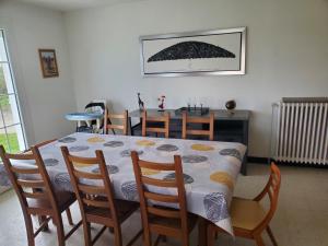 a dining room table and chairs with a table and a table and a table at A l'horizon du Mont in Pontorson +18 photos