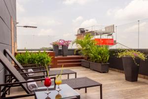 a balcony with tables and chairs and potted plants at VVC Hotel's in Villavicencio +40 photos