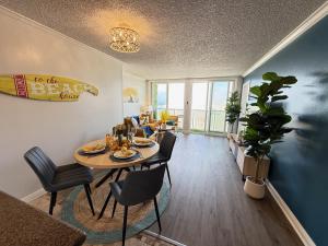a dining room and living room with a table and chairs at Oceanfront Sanctuary 1 BR Beach Access 218 in Hermosa Beach