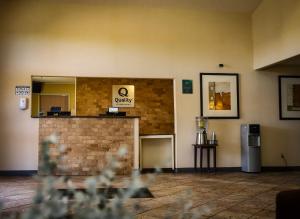 a bar in a room with a sign that says qualify at Quality Inn Airport in Colorado Springs +28 photos