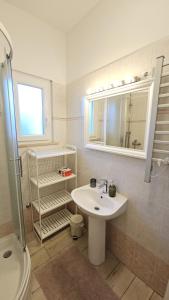 a bathroom with a sink and a mirror and a shower at Appartamento da Vjeri in Pula +19 photos