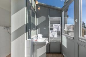 a bathroom with a sink and a window at Ferienhaus Rügenblick in Stahlbrode