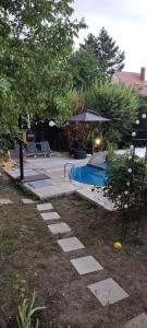 a swimming pool in a yard next to at Levendulás Ház Balatonakarattya in Balatonkenese