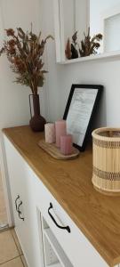a counter with a wooden counter top with a plant on it at Levendulás Ház Balatonakarattya in Balatonkenese