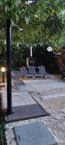 a row of benches sitting on a patio at Levendulás Ház Balatonakarattya in Balatonkenese