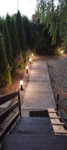 a pathway with two benches and lights on it at Levendulás Ház Balatonakarattya in Balatonkenese +3 photos