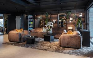 a living room with couches and tables at Thon Hotel Notodden in Notodden