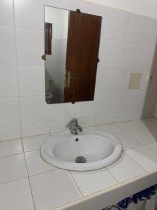 a bathroom with a sink and a mirror at Stash House in Cap Skirring +10 photos