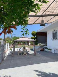 a patio with a picnic table and an umbrella at Diamond's House in Kallithea Halkidikis