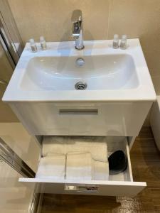 a white sink in a bathroom with towels at La casa di nonna chella in Bari +13 photos
