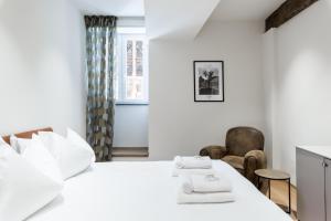 a bedroom with a bed and a table and chairs at History and Design Apartment Facing the Old Port in Genova