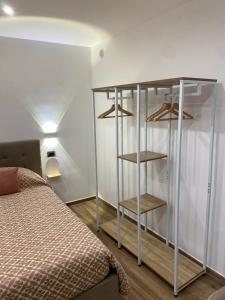 a bedroom with a bed and a book shelf at La casa di nonna chella in Bari