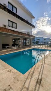 a large swimming pool in front of a building at Mountain View Penthouse Condo in Muñoz