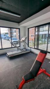 a red chair in a room with windows at Mountain View Penthouse Condo in Muñoz +82 photos
