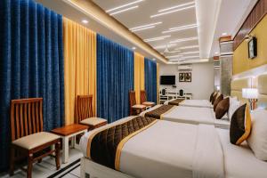 a hotel room with a bed and a salon at Excellency Airport Hotel in Angamaly
