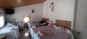 a bedroom with two beds with pink pillows on them at Villa Carmen in Alhama de Aragón +20 photos