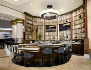 a bar in a restaurant with a lot of books at Salamander Washington DC in Washington