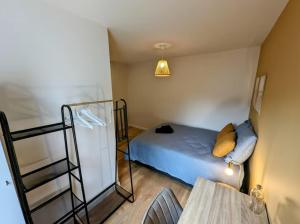 Ένα ή περισσότερα κρεβάτια σε δωμάτιο στο L'apostrophe - Duplex et terrasse