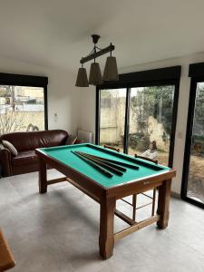 a ping pong table in a living room at Grand Paris Cozy Stay Private Studios and Apartment Quick Access to Paris in Vitry-sur-Seine