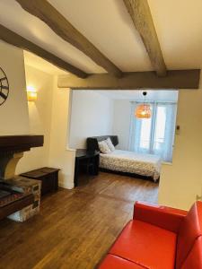 a living room with a couch and a bed at Grand Paris Cozy Stay Private Studios and Apartment Quick Access to Paris in Vitry-sur-Seine