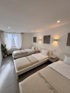 a bedroom with two beds and two windows at Maison Design in Langres