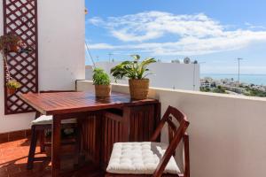 a table and chairs on a balcony with a view at Hillside Studio with Sea View & Fibre Internet in Albufeira
