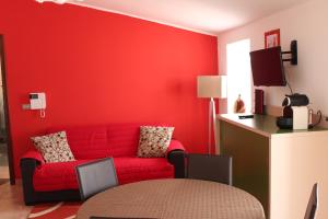 a red living room with a red couch and a table at Bed and Breakfast Dello Stretto in Villa San Giovanni