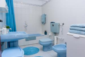 a bathroom with a blue toilet and a sink at Hillside Studio with Sea View & Fibre Internet in Albufeira