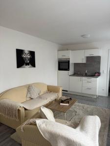 a living room with a couch and a table at Appartementshaus Vlora in Bad Füssing